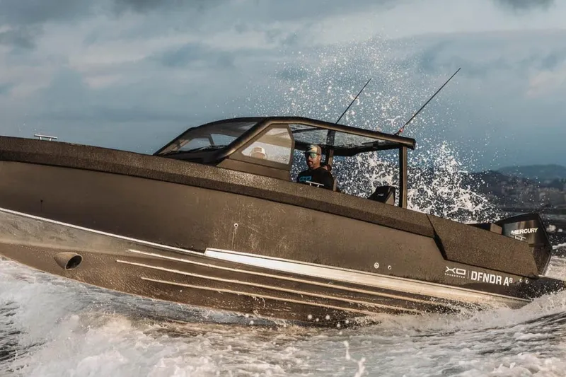 Slide: The Image of 2027 XO DFNDR 8 boat navigating through waves, showcasing sleek design and performance. - 5