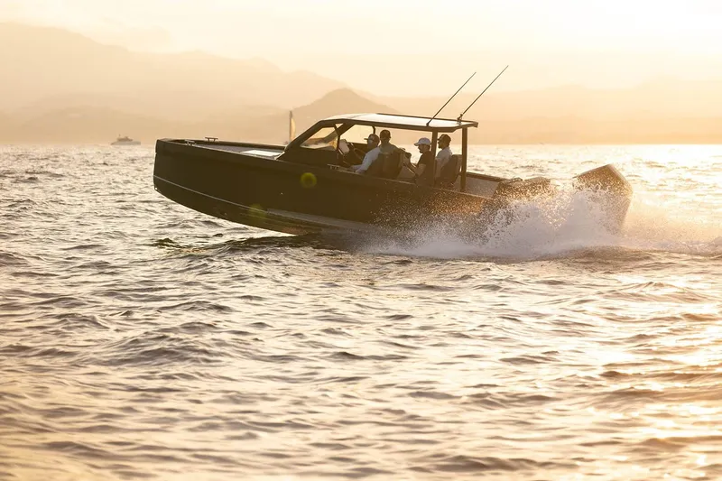 Slide: The Image of 2027 XO DFNDR 8 boat cruising at sunset on open water. - 7
