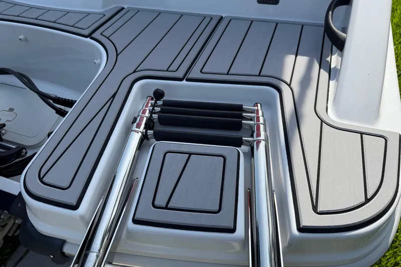Slide: The Image of 2023 Tahoe T18 boat deck with sleek design and retractable ladder. - 10