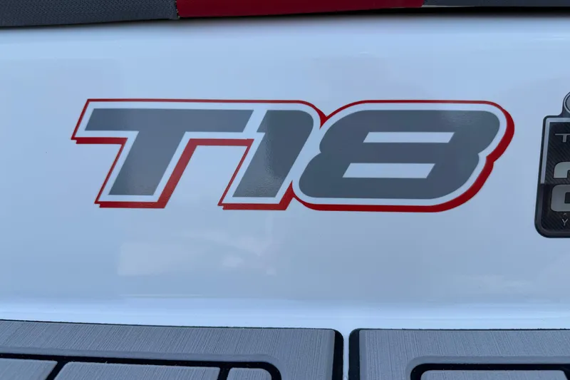 Slide: The Image of 2023 Tahoe T18 logo on white surface, featuring bold red and gray design. - 11