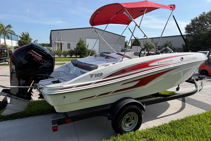 Slide: The Image of 2023 Tahoe T18 boat with red canopy and powerful outboard motor on trailer. - 16