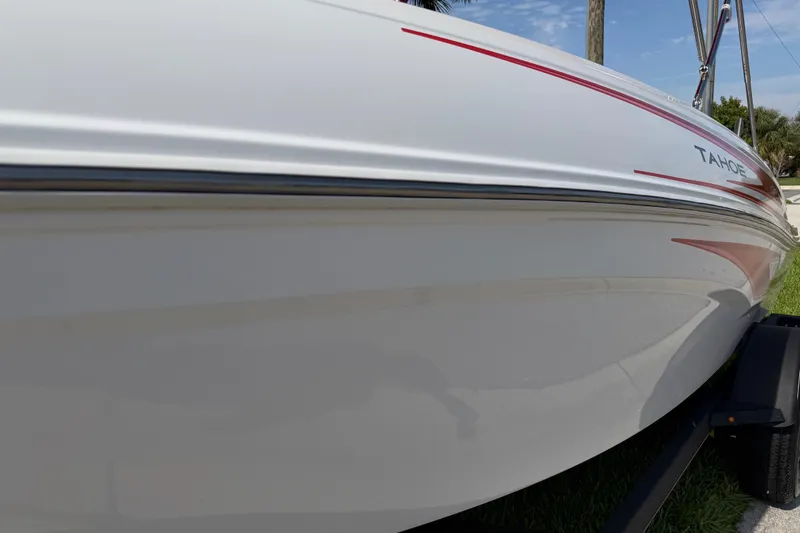 Slide: The Image of 2023 Tahoe T18 boat side view with sleek white and red design. - 23