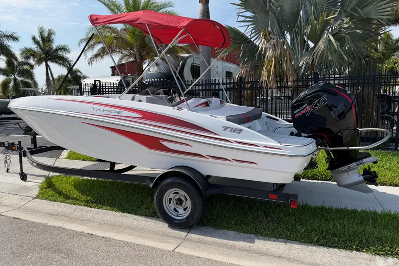 Slide: The Image of 2023 Tahoe T18 boat with red accents and outboard motor on trailer. - 3
