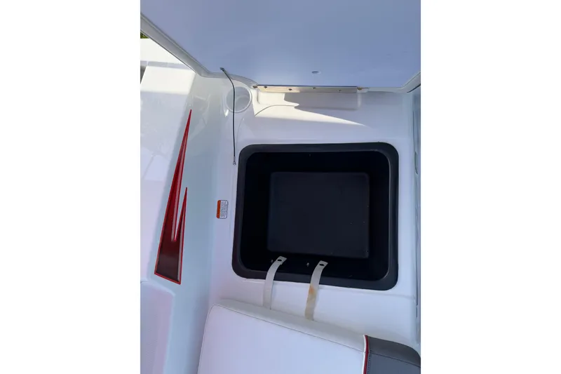 Slide: The Image of 2023 Tahoe T18 boat interior storage compartment with red accents. - 32