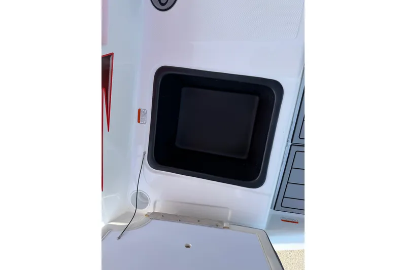 Slide: The Image of 2023 Tahoe T18 boat interior detail with storage compartment and control panel. - 33