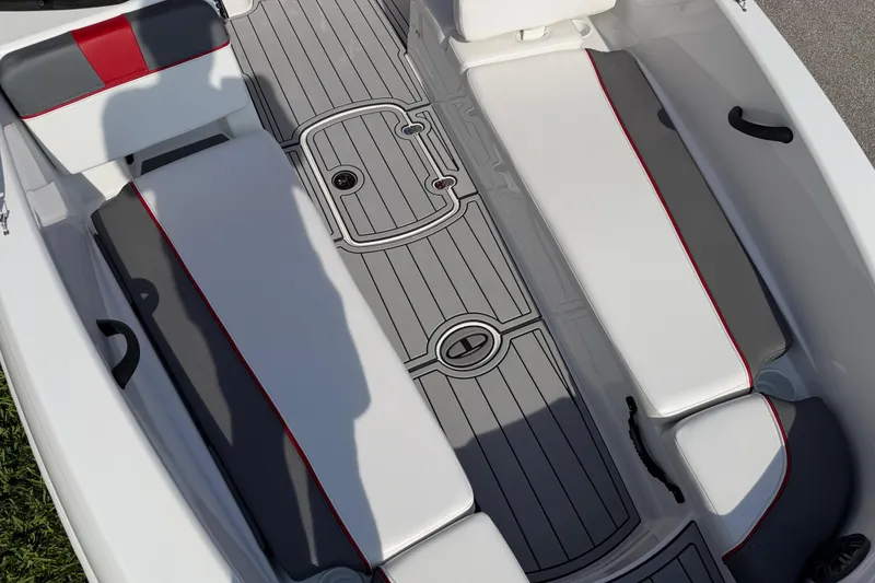 Slide: The Image of 2023 Tahoe T18 boat interior with gray and white seating, red accents, and textured flooring. - 41