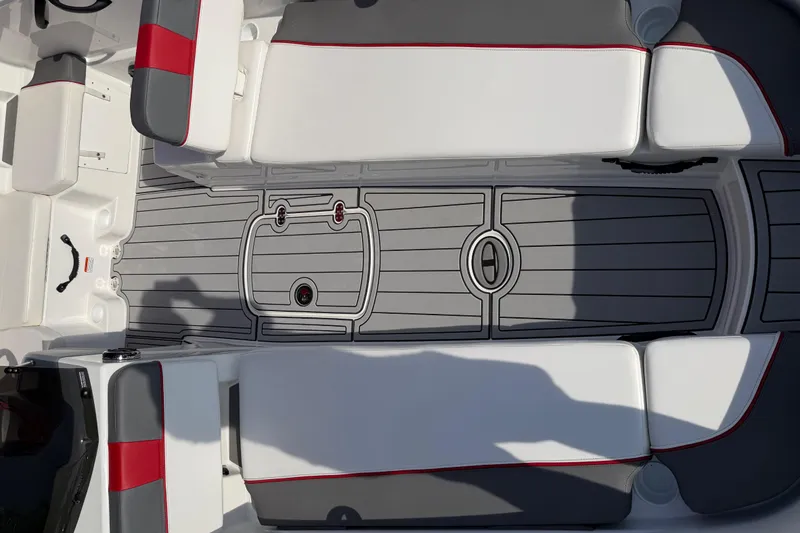 Slide: The Image of 2023 Tahoe T18 boat interior with gray flooring and white-red seating. - 43