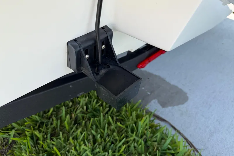 Slide: The Image of 2023 Tahoe T18 boat transducer mounted near grass and pavement. - 5
