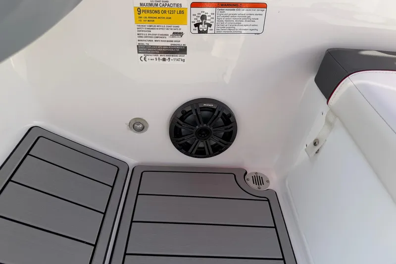 Slide: The Image of 2023 Tahoe T18 boat interior with speaker and capacity warning label. - 51