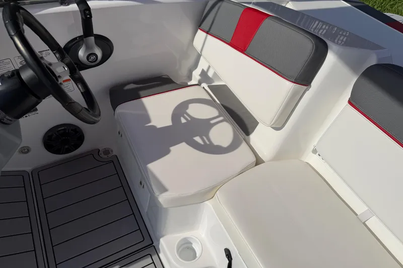 Slide: The Image of Interior of 2023 Tahoe T18 boat with steering wheel and cushioned seating. - 52
