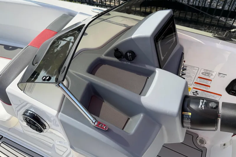 Slide: The Image of 2023 Tahoe T18 boat dashboard with steering wheel and control panel. - 53
