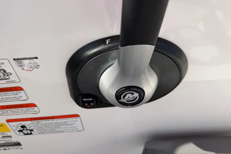 Slide: The Image of Close-up of 2023 Tahoe T18 boat throttle control with warning labels. - 54