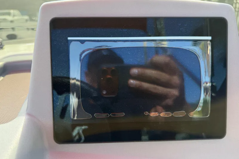 Slide: The Image of Dashboard screen of a 2023 Tahoe T18 boat with reflection. - 56