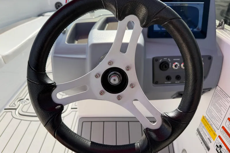 Slide: The Image of Steering wheel of 2023 Tahoe T18 boat with dashboard controls. - 57