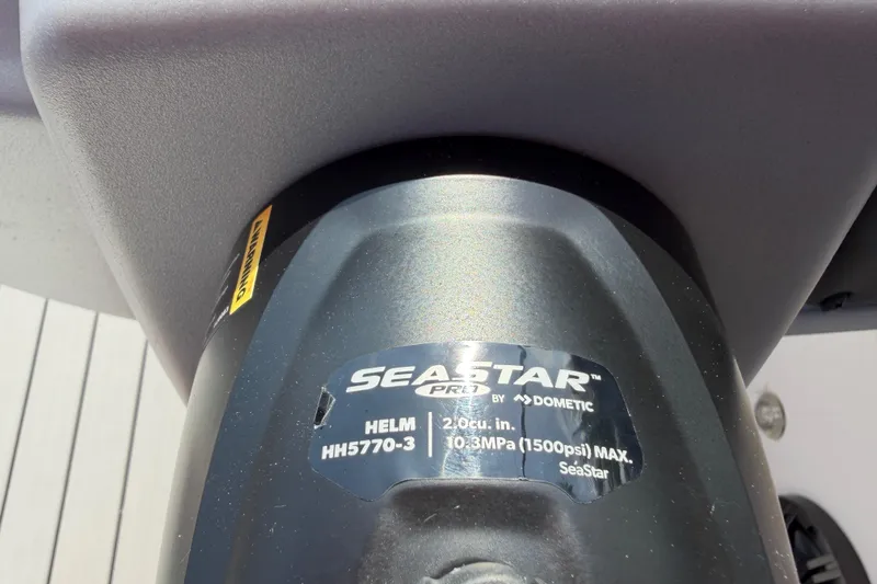 Slide: The Image of Close-up of SeaStar hydraulic helm on 2023 Tahoe T18 boat. - 58