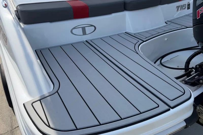 Slide: The Image of 2023 Tahoe T18 boat deck with sleek gray flooring and seating. - 6