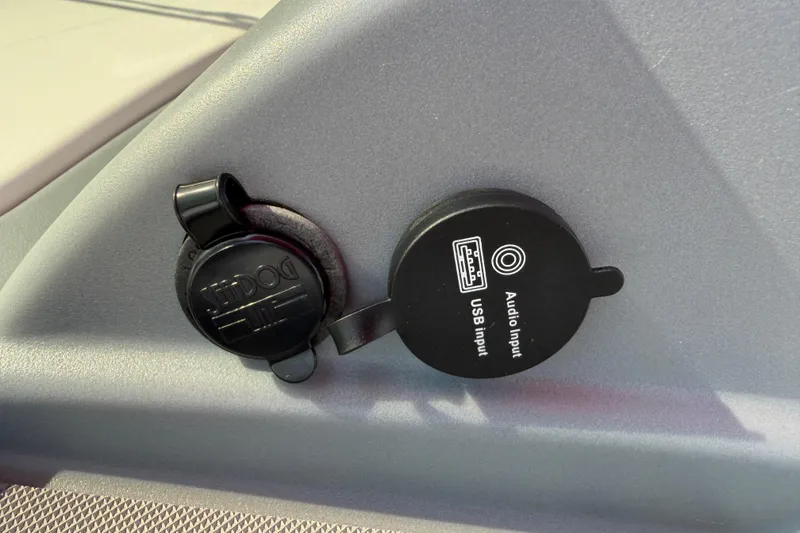 Slide: The Image of 2023 Tahoe T18 USB and audio input ports on a gray panel. - 62
