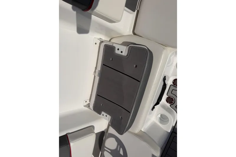 Slide: The Image of 2023 Tahoe T18 boat interior with gray cushioned seating and cup holder. - 65