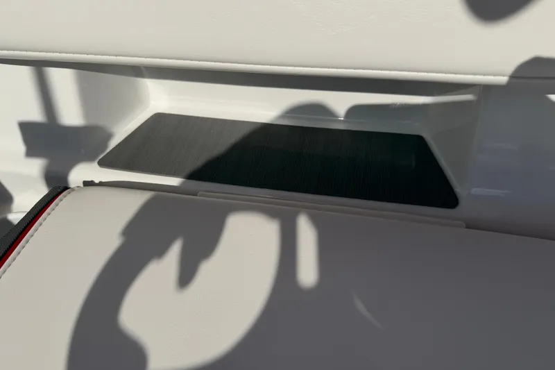 Slide: The Image of 2023 Tahoe T18 boat interior with white seating and shadow details. - 67