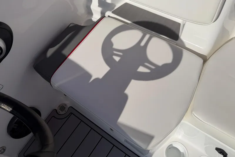 Slide: The Image of 2023 Tahoe T18 boat interior with steering wheel shadow on white seat. - 68