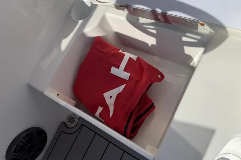 Slide: The Image of Storage compartment in 2023 Tahoe T18 boat with red cover inside. - 69