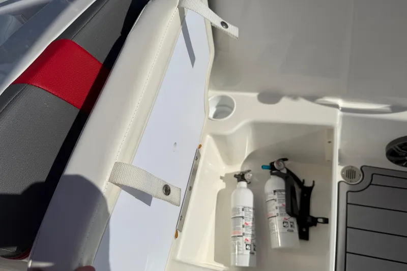 Slide: The Image of 2023 Tahoe T18 boat interior with storage compartment and fire extinguishers. - 71