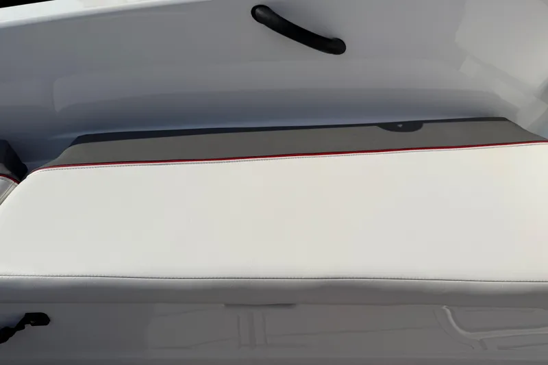 Slide: The Image of 2023 Tahoe T18 boat seat with white and gray upholstery, featuring red stitching. - 79