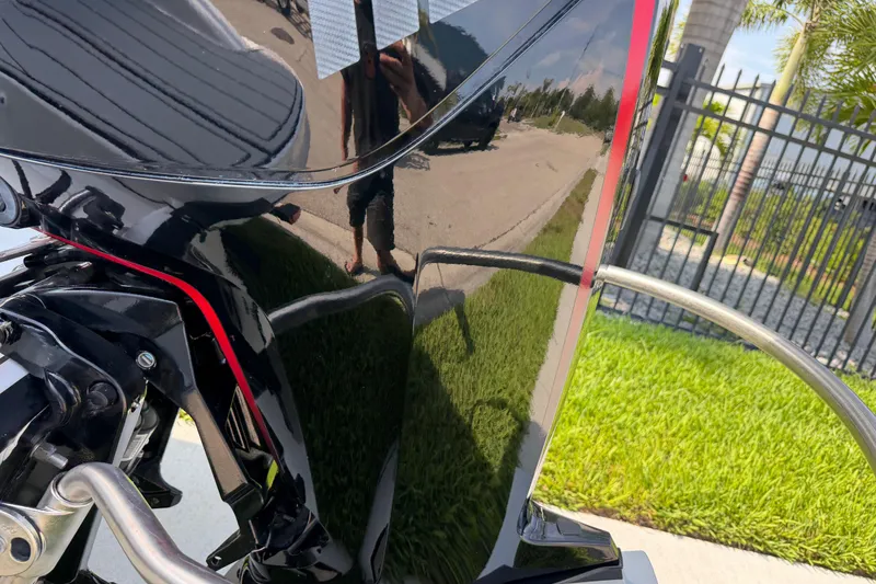 Slide: The Image of 2023 Tahoe T18 boat engine with shiny black finish and red accents. - 8