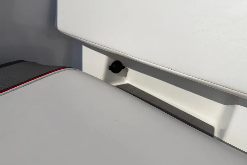 Slide: The Image of 2023 Tahoe T18 boat seat detail with white upholstery and red accent. - 80