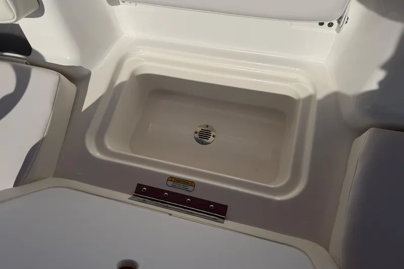 Slide: The Image of 2023 Tahoe T18 boat interior with built-in storage compartment. - 82