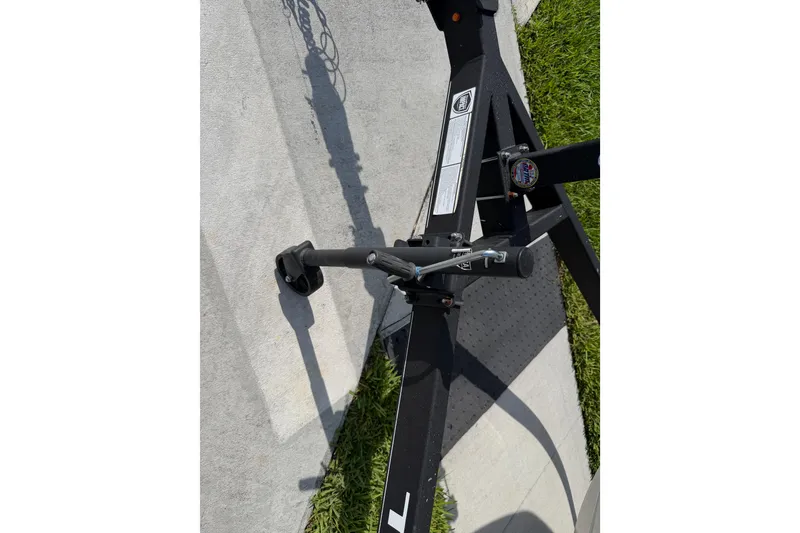 Slide: The Image of Trailer hitch of a 2023 Tahoe T18 boat on concrete and grass. - 85