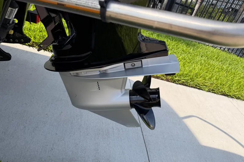 Slide: The Image of 2023 Tahoe T18 boat motor and propeller on concrete surface. - 9
