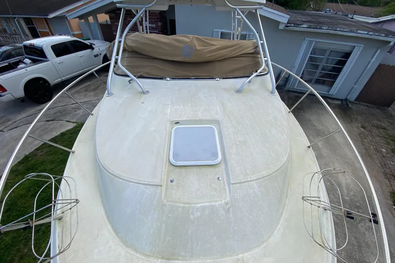 Slide: The Image of 2002 Wellcraft 290 Coastal boat on driveway, with white truck nearby. - 18