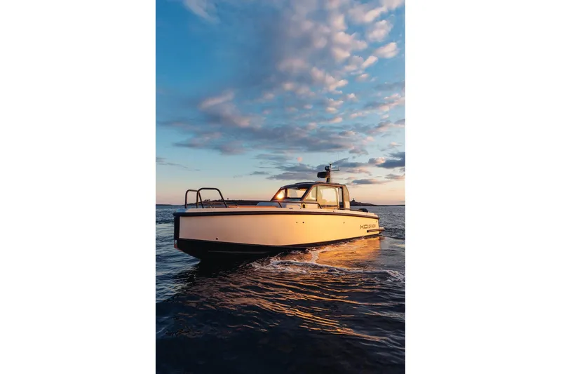 Slide: The Image of 2027 XO DFNDR 9 boat on water at sunset, showcasing sleek design and modern features. - 18