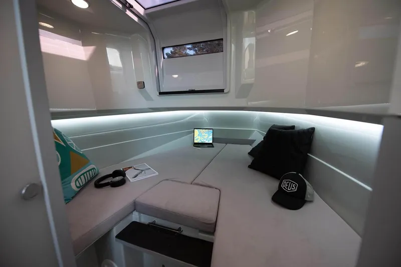 Slide: The Image of Modern interior of 2027 XO DFNDR 9 boat with cozy seating and ambient lighting. - 2