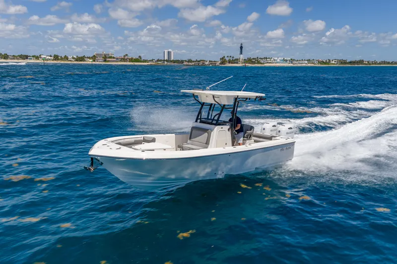The Image of 2026 Sea Born LX27 Center Console boat cruising on open blue water. - 0