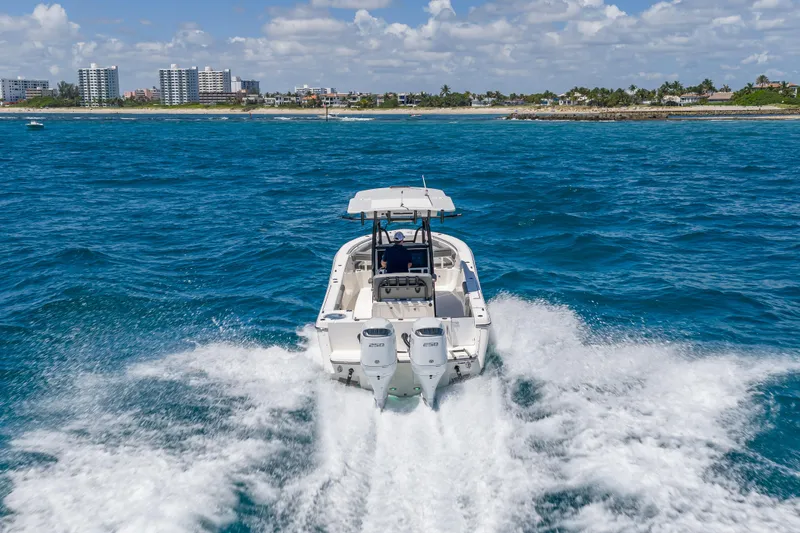 Slide: The Image of 2026 Sea Born LX27 Center Console cruising on blue ocean near coastline. - 10