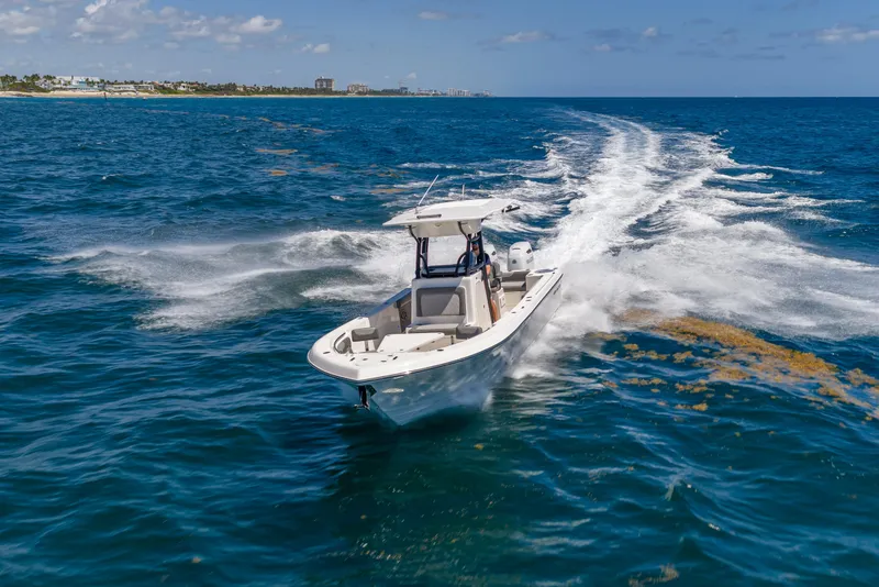 Slide: The Image of 2026 Sea Born LX27 Center Console cruising on open ocean waters. - 13