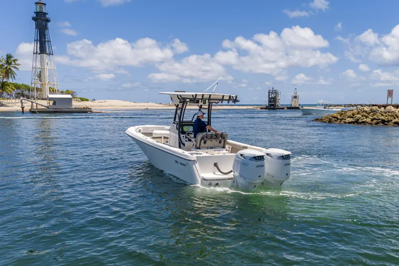 Slide: The Image of 2026 Sea Born LX27 Center Console boat cruising near a lighthouse on a sunny day. - 15