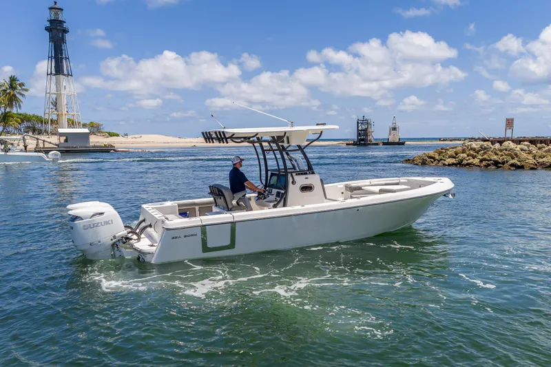 Slide: The Image of 2026 Sea Born LX27 Center Console boat cruising near a lighthouse on a sunny day. - 17
