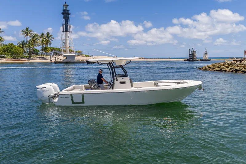 Slide: The Image of 2026 Sea Born LX27 Center Console boat cruising near a lighthouse on a sunny day. - 18