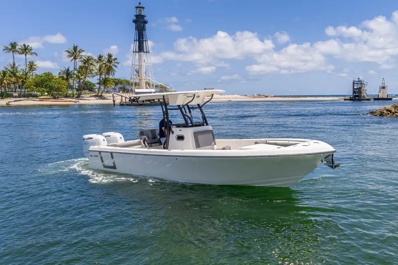 Slide: The Image of 2026 Sea Born LX27 Center Console boat cruising near a lighthouse on a sunny day. - 19