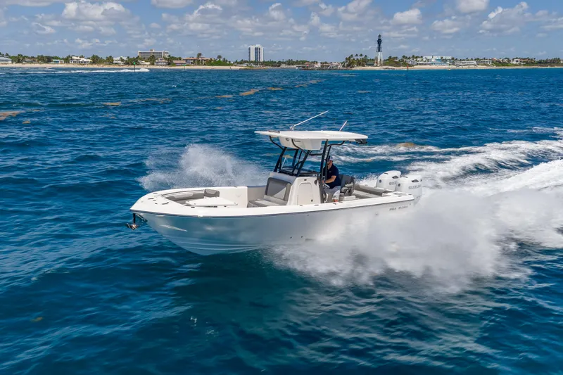 Slide: The Image of 2026 Sea Born LX27 Center Console boat cruising on open water. - 2