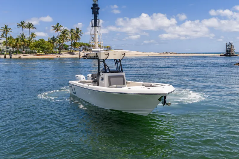 Slide: The Image of 2026 Sea Born LX27 Center Console boat cruising near a tropical island with palm trees. - 20