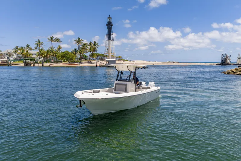 Slide: The Image of 2026 Sea Born LX27 Center Console boat near lighthouse, clear blue sky, and palm trees. - 21