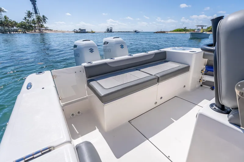 Slide: The Image of 2026 Sea Born LX27 Center Console boat with dual Suzuki engines on calm water. - 23