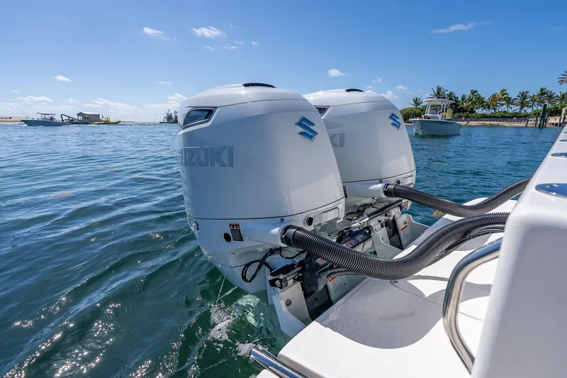 Slide: The Image of 2026 Sea Born LX27 Center Console with dual Suzuki outboard motors on water. - 26