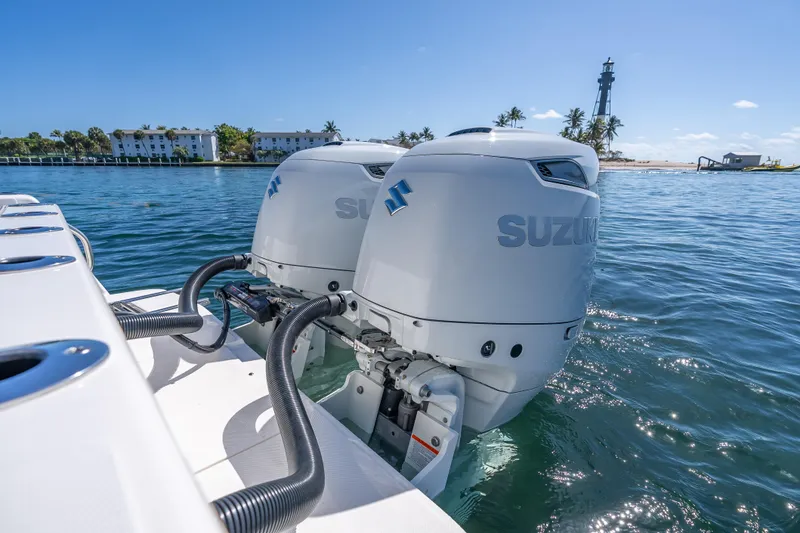 Slide: The Image of 2026 Sea Born LX27 Center Console with Suzuki outboard engines on water. - 27