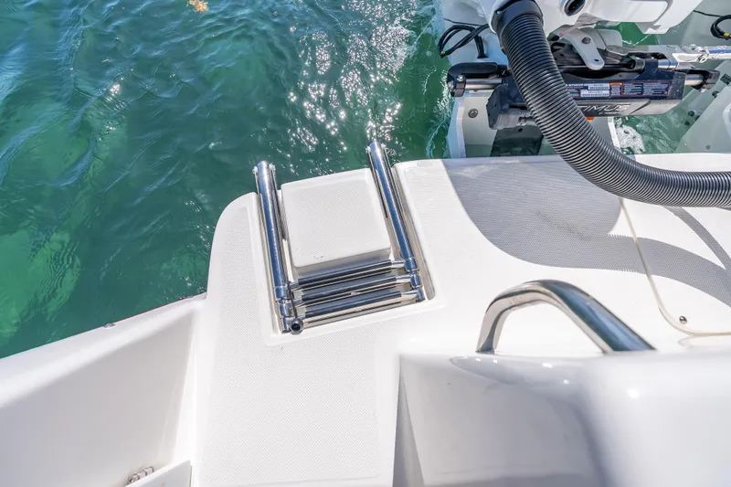 Slide: The Image of 2026 Sea Born LX27 Center Console boat with stainless steel swim ladder and clear water view. - 29