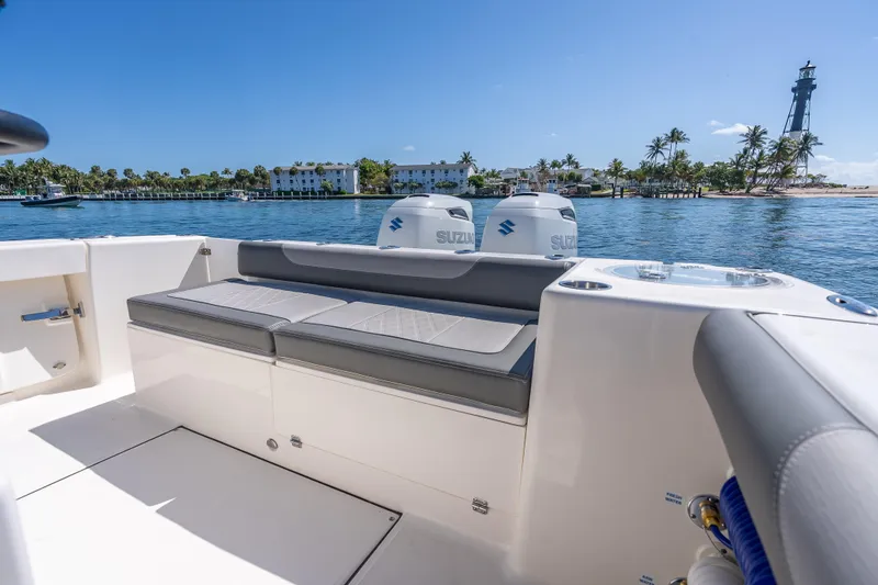 Slide: The Image of 2026 Sea Born LX27 Center Console boat with seating, ocean view, and lighthouse in background. - 30